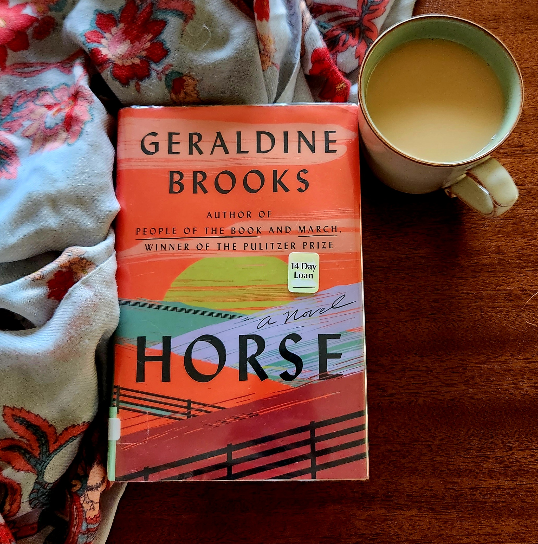 Book cover of HORSE by Geraldine Brooks, with a cup of tea and a floral scarf in background