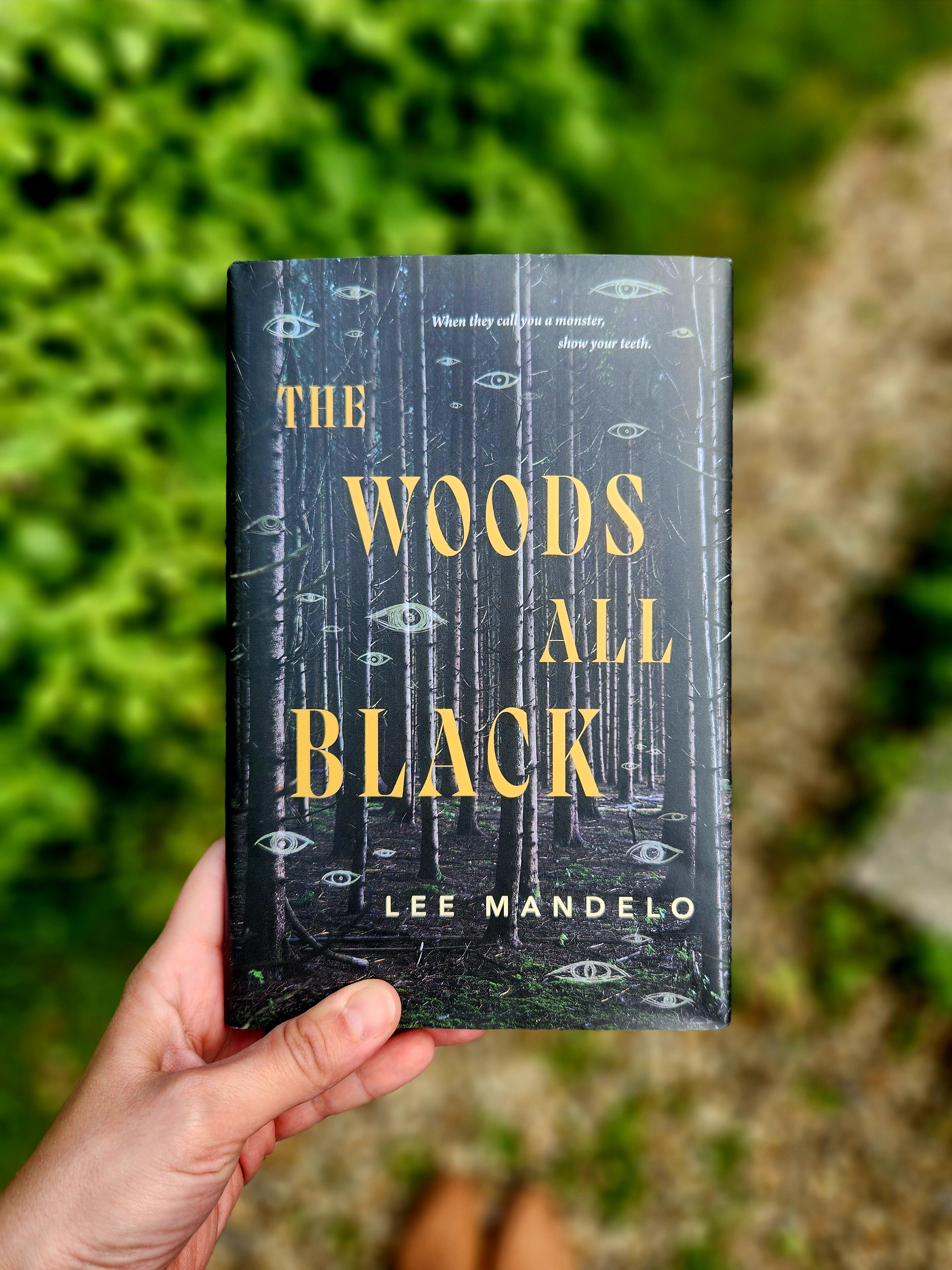 book cover of the woods all black by lee mandelo