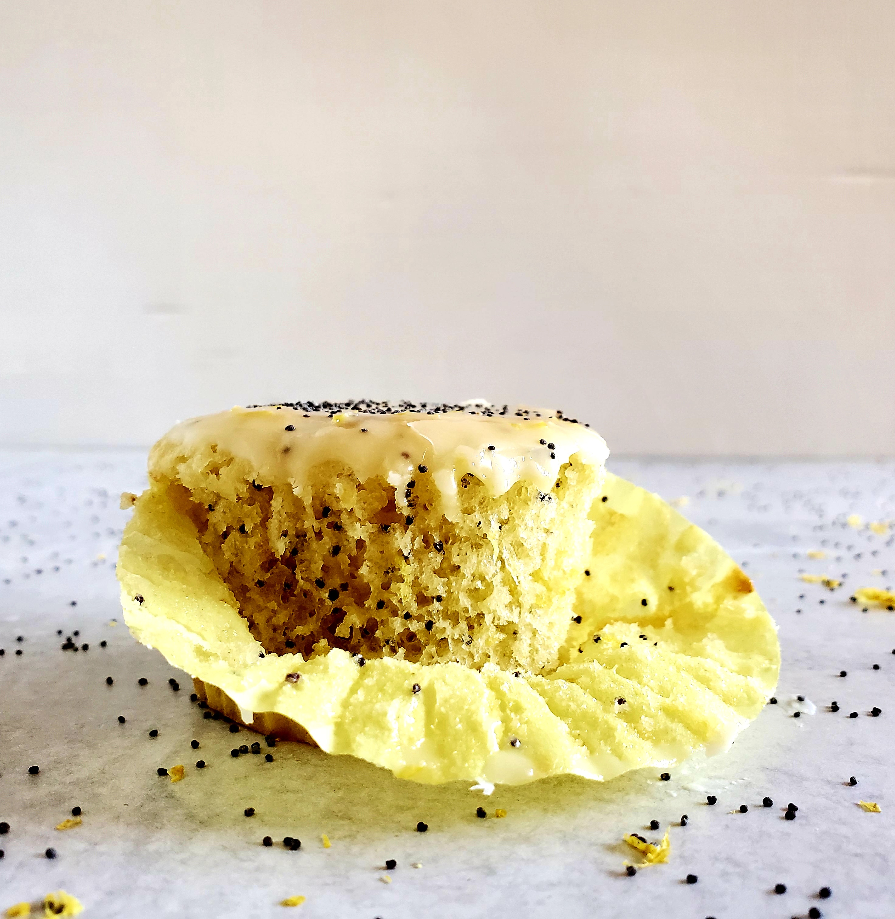 Lemon Poppy Seed Muffin with half-peeled yellow muffin wrapper